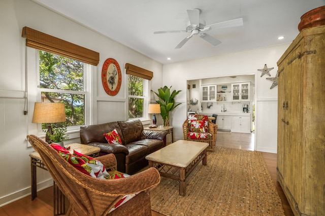 living area featuring wood finished floors, a ceiling fan, and recessed lighting