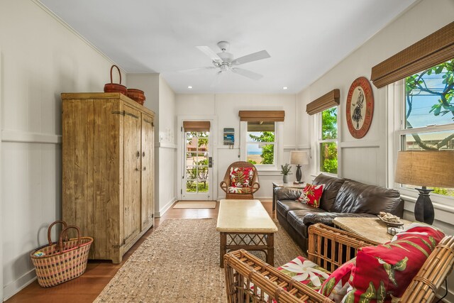 living area featuring wood finished floors, a ceiling fan, and recessed lighting