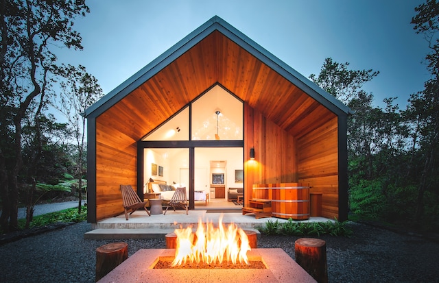 back house at dusk with a fire pit