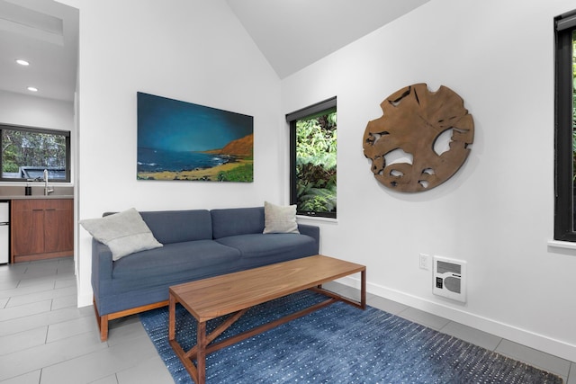 tiled living room featuring heating unit and vaulted ceiling