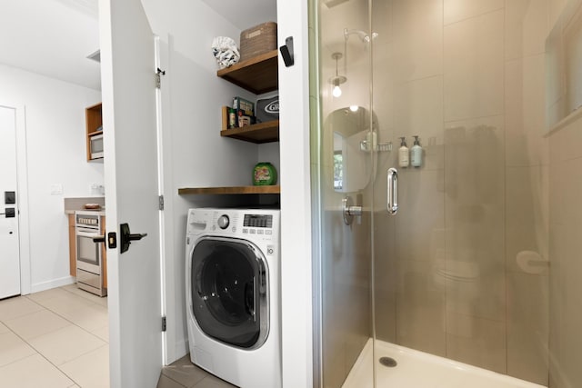 laundry room featuring light tile patterned floors and washer / dryer