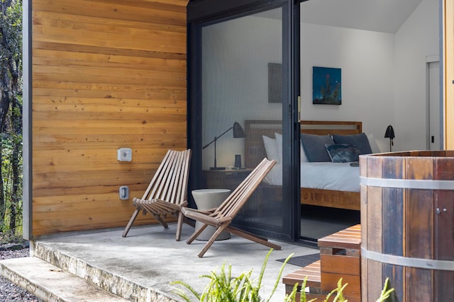 bedroom featuring wood walls and carpet flooring