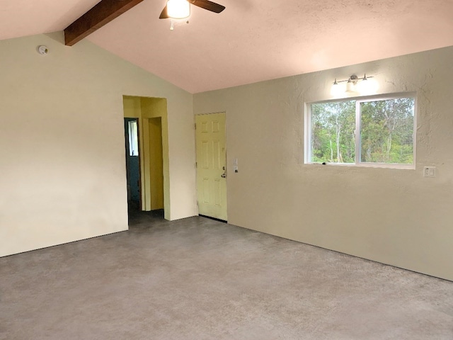 spare room with vaulted ceiling with beams, concrete floors, and ceiling fan