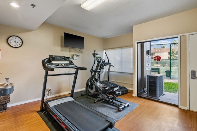 exercise room with hardwood / wood-style flooring