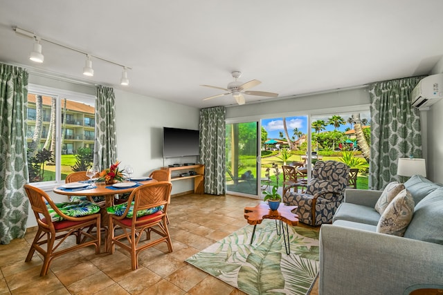 living room featuring a wall unit AC, ceiling fan, rail lighting, and light tile patterned flooring