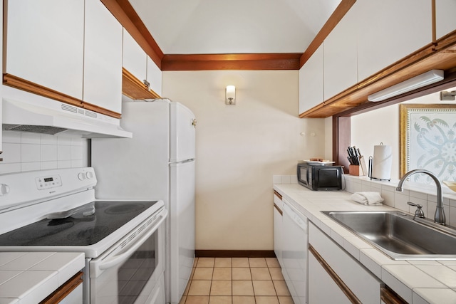 kitchen with decorative backsplash, white cabinets, white appliances, and sink