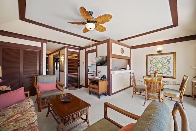 carpeted living room featuring ceiling fan