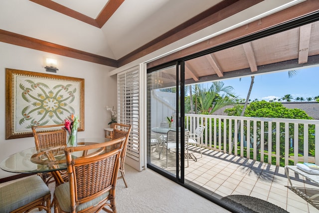 dining room featuring vaulted ceiling with beams and tile patterned flooring