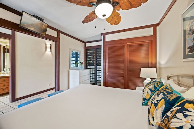 bedroom with ceiling fan, light tile patterned flooring, a closet, and crown molding