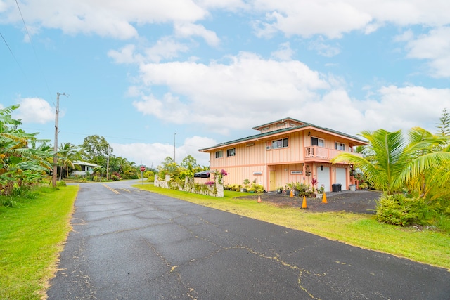 view of front of house with a front yard and a garage