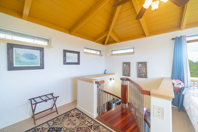 stairs with wood ceiling, vaulted ceiling with beams, tile patterned flooring, and a healthy amount of sunlight