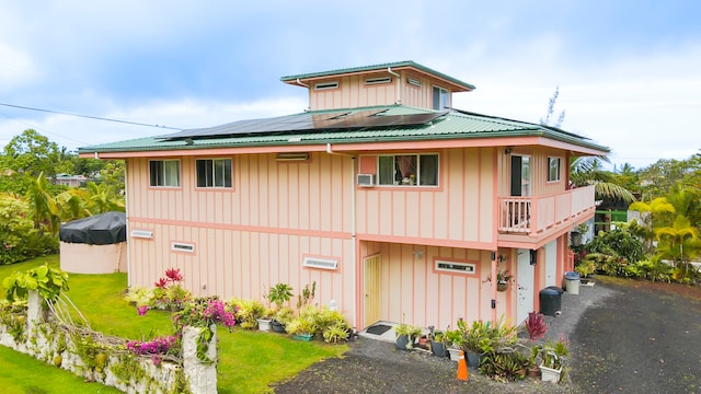 view of front of house featuring solar panels and a front yard