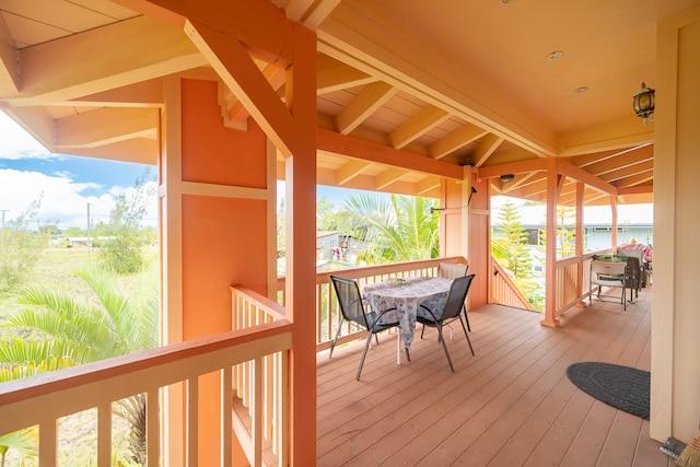 wooden terrace featuring a water view