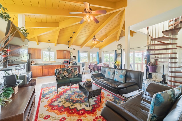 living room with lofted ceiling with beams, light tile patterned floors, wooden ceiling, ceiling fan, and sink