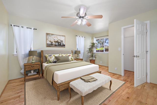 bedroom with light wood-type flooring and ceiling fan