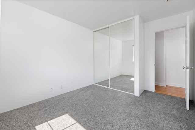 unfurnished bedroom with a closet and carpet