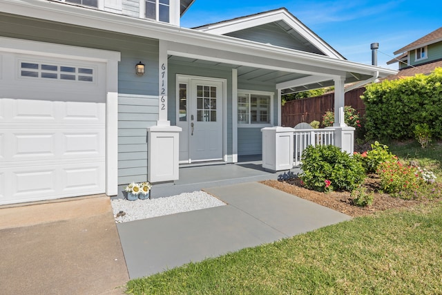 doorway to property with covered porch and a lawn