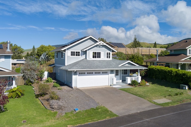 view of front of property with a front yard, a garage, and covered porch