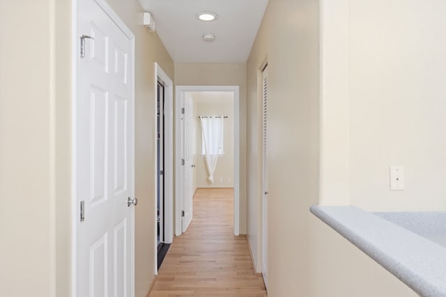 corridor with light hardwood / wood-style flooring