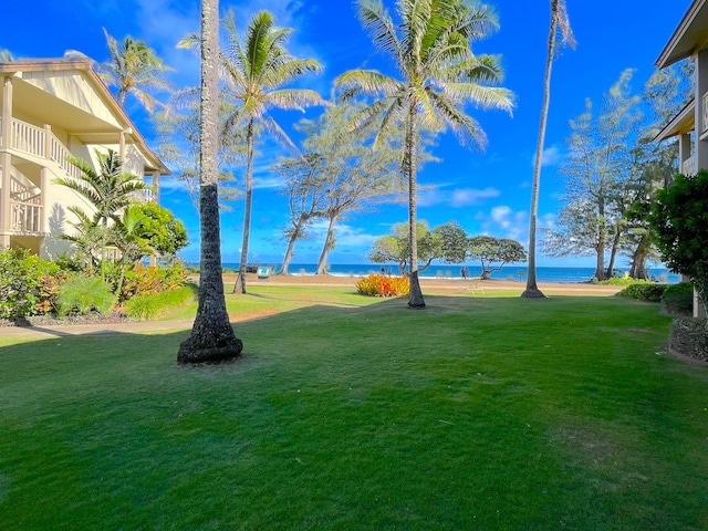 view of yard featuring a balcony and a water view