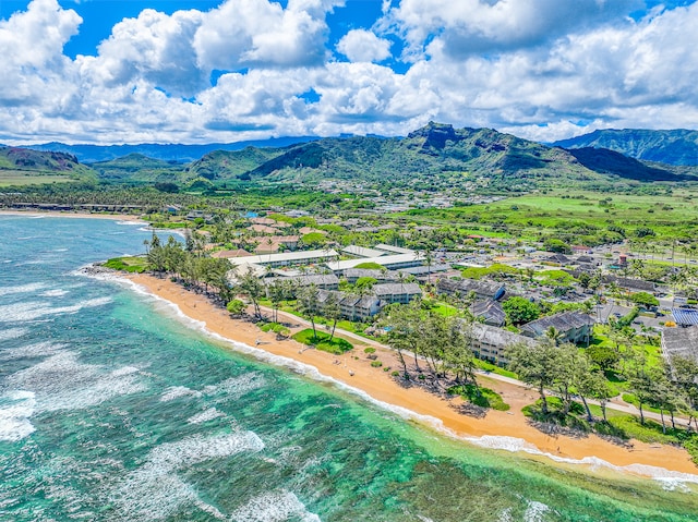 aerial view featuring a view of the beach and a water and mountain view