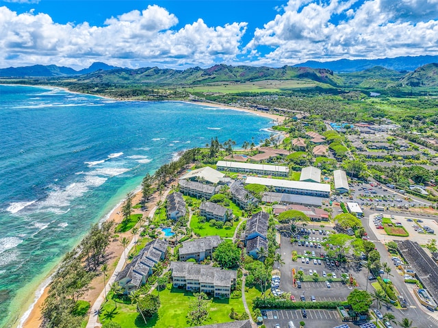 aerial view featuring a water and mountain view and a beach view