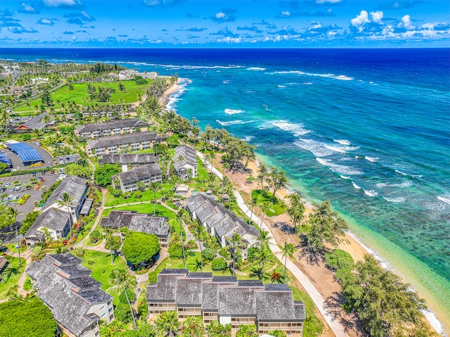 drone / aerial view featuring a water view and a view of the beach