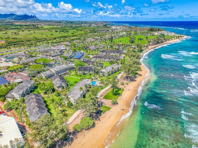 drone / aerial view with a water view and a beach view