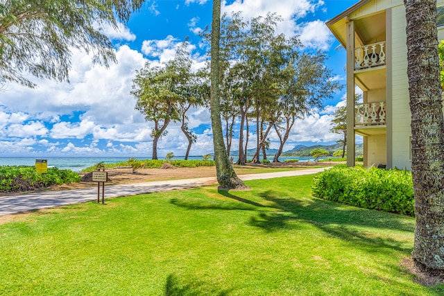 view of yard featuring a water view and a balcony