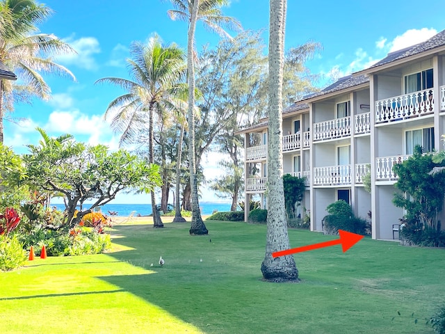 view of home's community featuring a yard and a water view