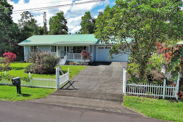 ranch-style house featuring a garage, a front lawn, and covered porch