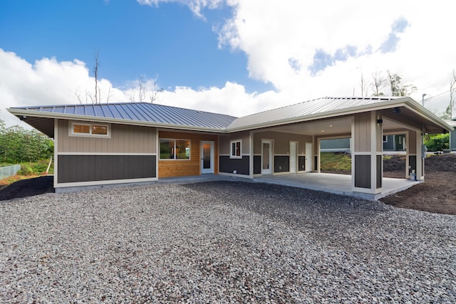 16-2157 Jewel Dr, Pahoa, HI 96778 - rear view of property featuring a patio, driveway, metal roof, and an attached carport