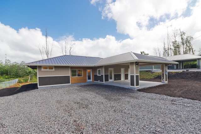 16-2157 Jewel Dr, Pahoa, HI 96778 - view of front of house featuring metal roof, an attached carport, driveway, and a patio area