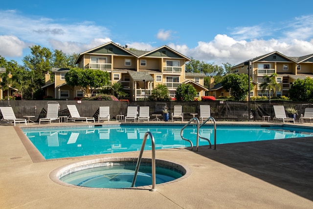 view of pool featuring a hot tub