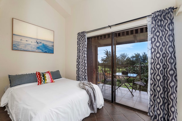 bedroom with dark tile patterned flooring and access to outside