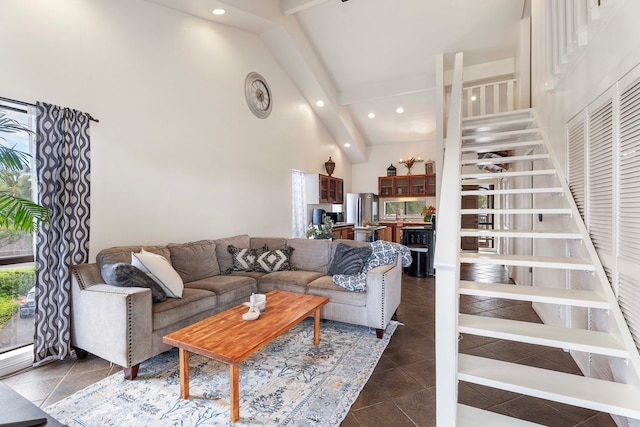 living room featuring beamed ceiling and high vaulted ceiling