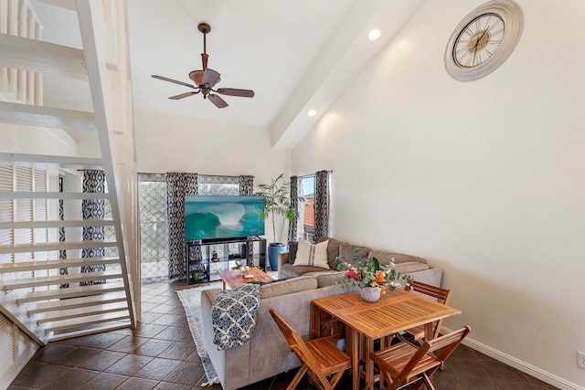 dining room with a high ceiling and ceiling fan