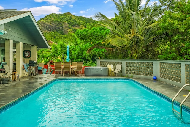 view of pool featuring a patio and a mountain view