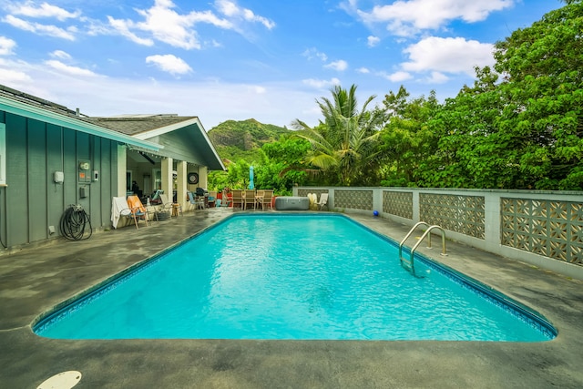 view of pool featuring a mountain view and a patio