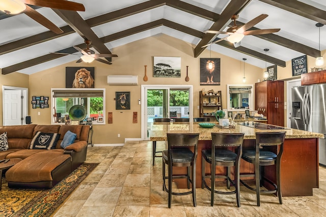 kitchen featuring a breakfast bar, light stone countertops, decorative light fixtures, and stainless steel fridge with ice dispenser