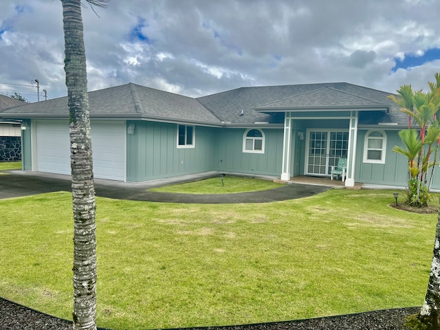 view of front of house featuring a garage and a front lawn