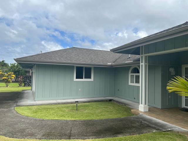 view of side of home with a lawn