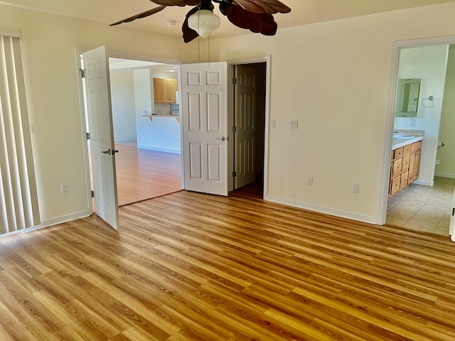 unfurnished bedroom with connected bathroom, light hardwood / wood-style floors, and ceiling fan