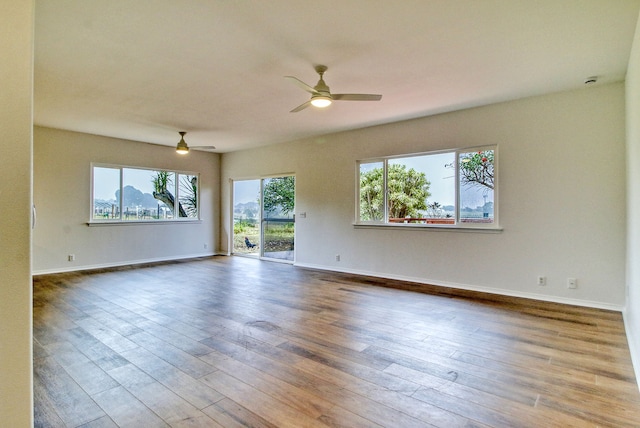 unfurnished room with ceiling fan and wood-type flooring