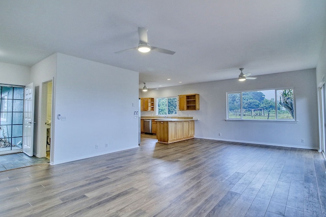 unfurnished living room with ceiling fan and light hardwood / wood-style floors