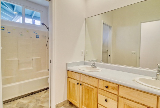 bathroom with toilet, shower / bathtub combination, double vanity, and a sink