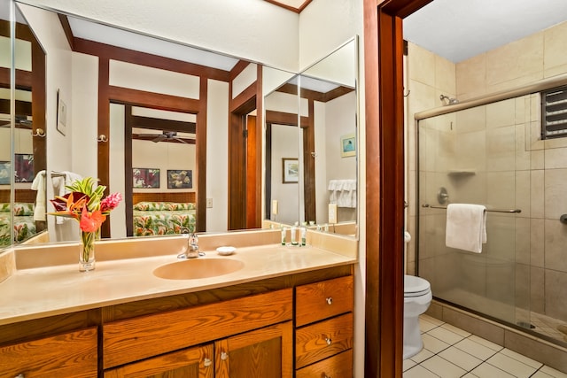 bathroom with vanity, tile patterned flooring, ceiling fan, toilet, and an enclosed shower