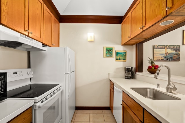 kitchen with white appliances, sink, and light tile patterned floors