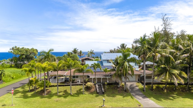 view of property's community featuring a water view and a yard