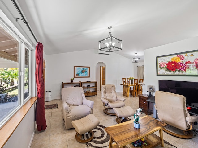 living room featuring light tile patterned floors, vaulted ceiling, and a chandelier